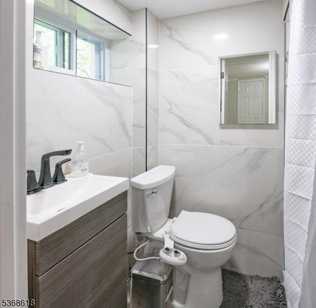 724 Bloomfield Ave, Clifton City, NJ 07012 - bathroom with tile walls and vanity