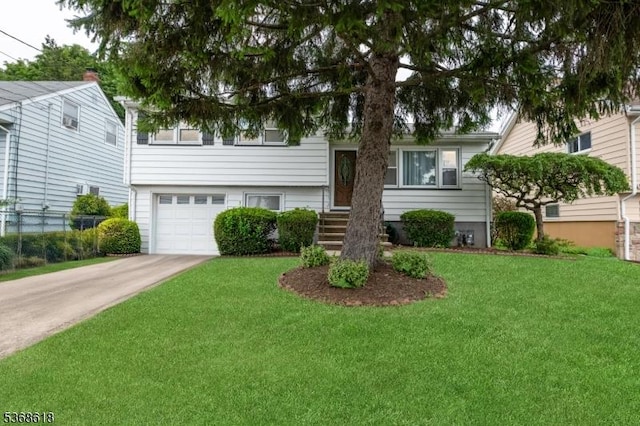724 Bloomfield Ave, Clifton City, NJ 07012 - split level home with a front lawn, an attached garage, and concrete driveway