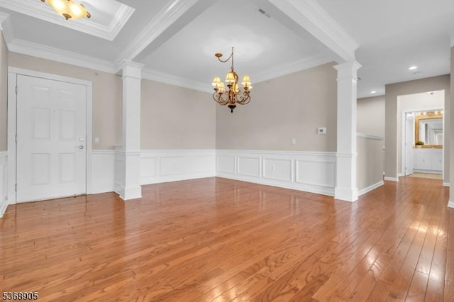 3304 Chesterwood Way, Franklin Twp, NJ 08873 - unfurnished room featuring decorative columns, light wood-style flooring, a chandelier, a wainscoted wall, and crown molding