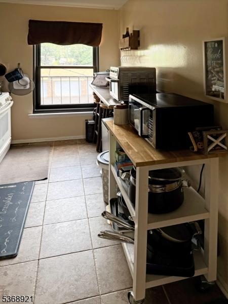 58 Sandra Cir Unit B3, Westfield Town, NJ 07090 - kitchen featuring stainless steel microwave and tile patterned floors