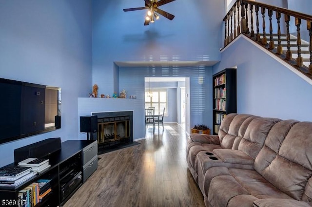 277 Edgeware Ct, Franklin Twp, NJ 08873 - living room featuring a towering ceiling, ceiling fan, wood finished floors, a fireplace with flush hearth, and stairs