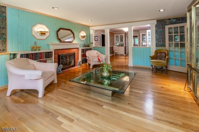 29 Clement Ave, Ewing Twp, NJ 08638 - living room featuring decorative columns, ornamental molding, a fireplace, and wood finished floors