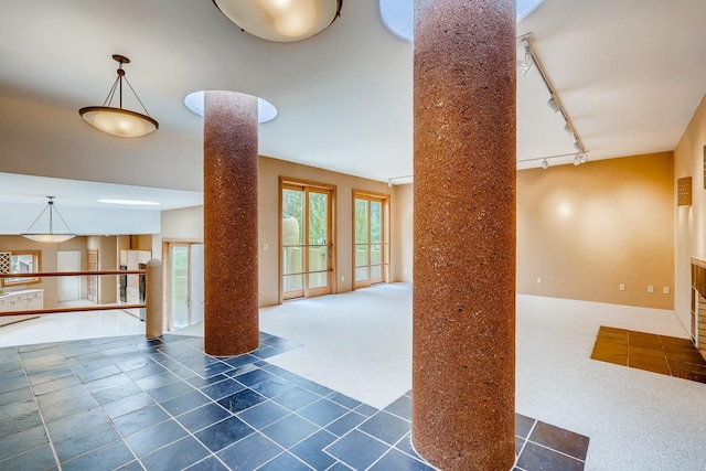 living room featuring dark tile flooring and rail lighting