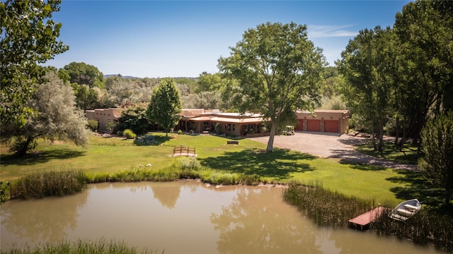 surrounding community featuring a lawn and a water view