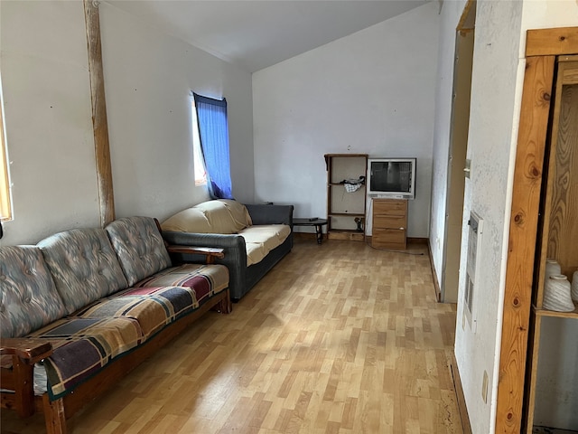 living room with light hardwood / wood-style floors and lofted ceiling