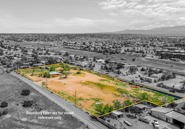 birds eye view of property with a mountain view