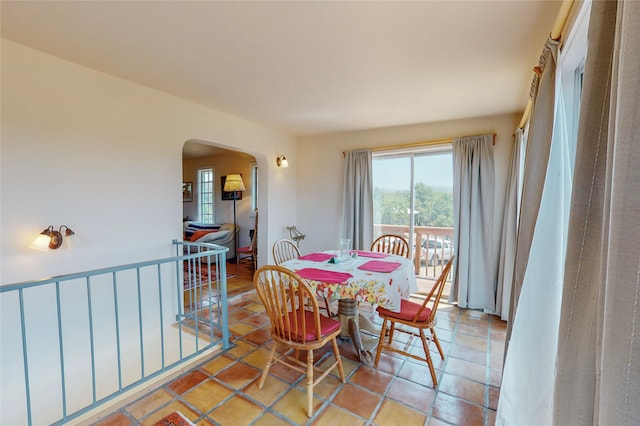 tiled dining room with arched walkways