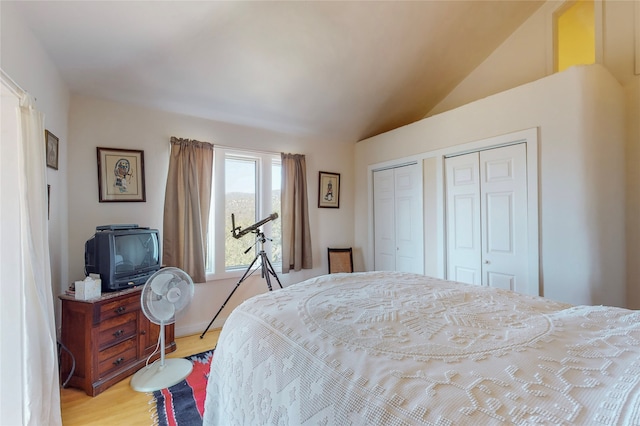 bedroom featuring light wood-style flooring and lofted ceiling