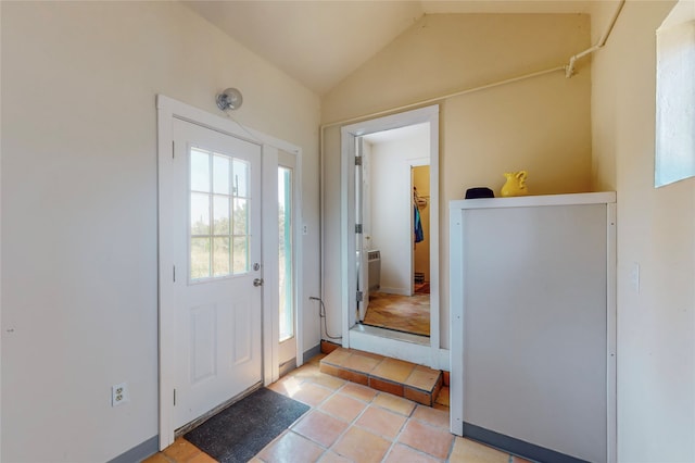 entrance foyer with lofted ceiling and light tile patterned floors