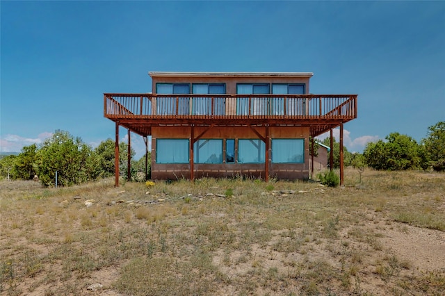 back of house featuring a wooden deck