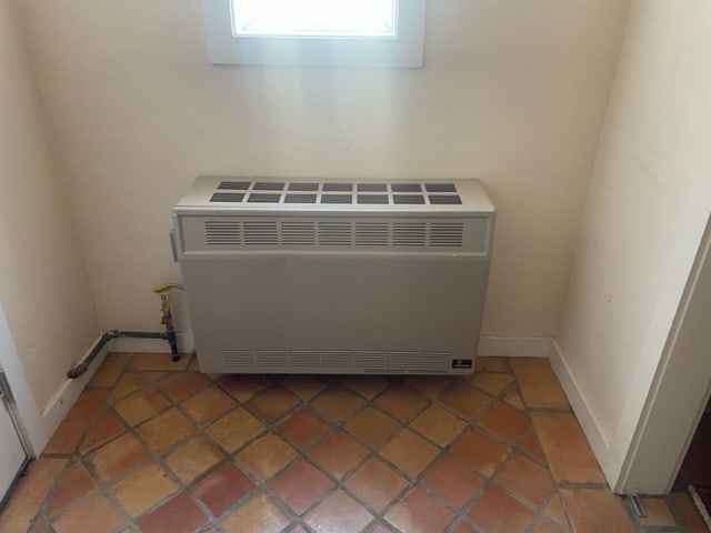 interior details with heating unit and baseboards