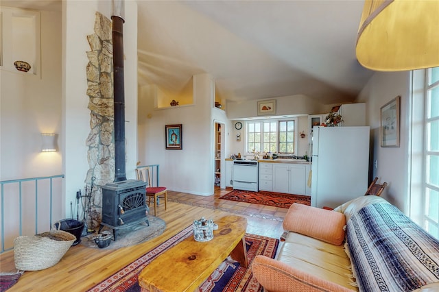 living room with a wood stove and light wood-style flooring