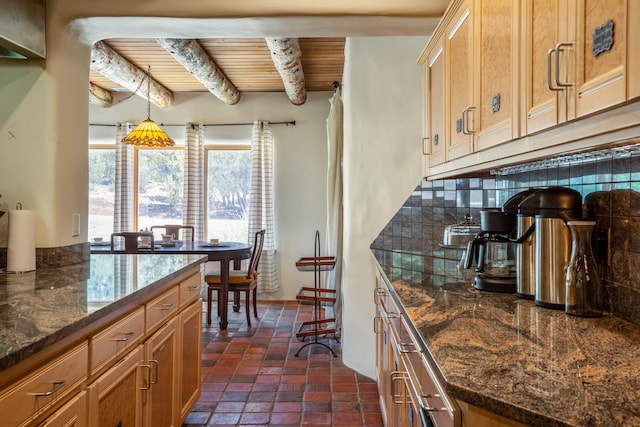 kitchen with pendant lighting, beam ceiling, wood ceiling, and dark stone countertops