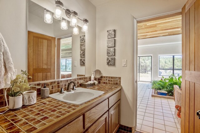35 Camino Monte Azul, Arroyo Hondo, NM 87571 - bathroom with decorative backsplash, vanity, healthy amount of natural light, and tile patterned floors