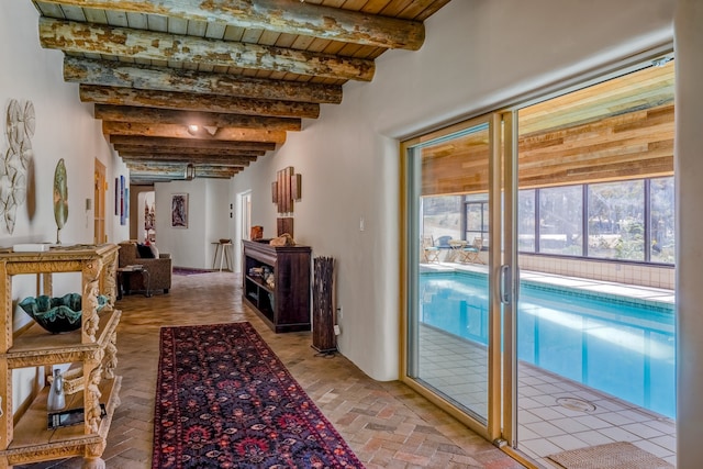 hall with wood ceiling and beamed ceiling