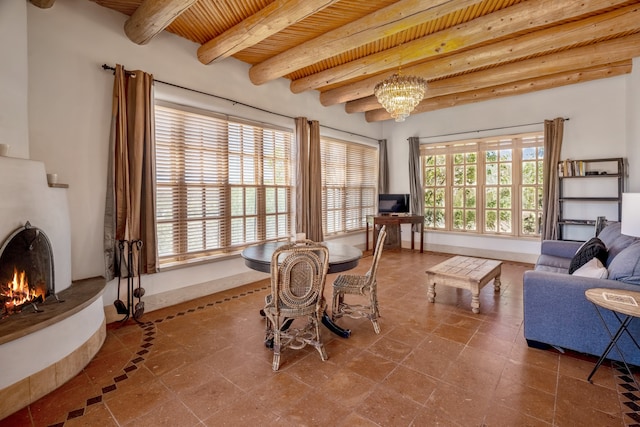 interior space featuring plenty of natural light, wooden ceiling, beam ceiling, and a notable chandelier