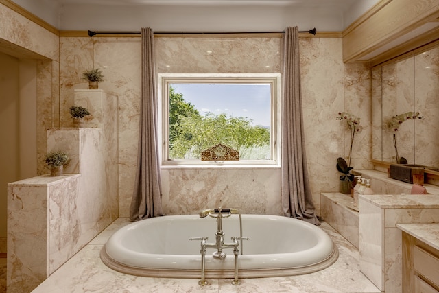 bathroom featuring vanity and a relaxing tiled tub