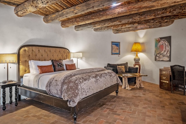 35 Camino Monte Azul, Arroyo Hondo, NM 87571 - bedroom with brick flooring and a wood ceiling with exposed beams