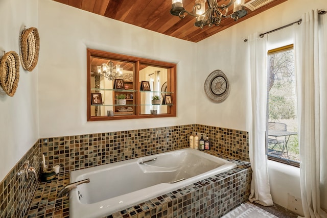 bathroom with tiled bath, wood ceiling, and a notable chandelier