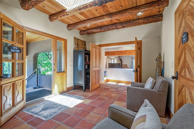 tiled living room featuring wood ceiling and beam ceiling