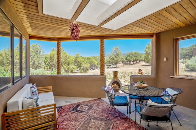 sunroom / solarium with wood ceiling and a healthy amount of sunlight