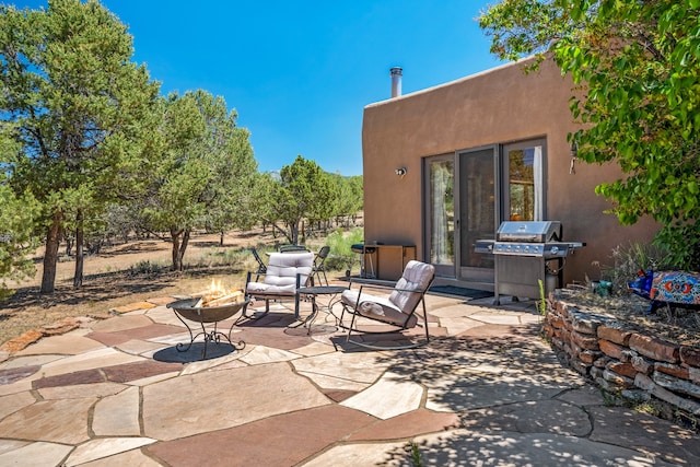 view of patio with a grill and an outdoor fire pit