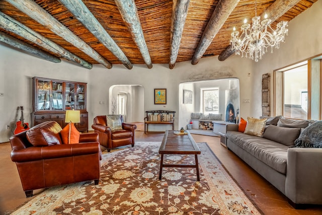 living room featuring a healthy amount of sunlight, wood ceiling, beam ceiling, and a notable chandelier