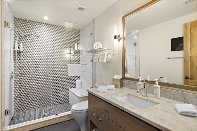 bathroom with an enclosed shower, tile floors, large vanity, and toilet