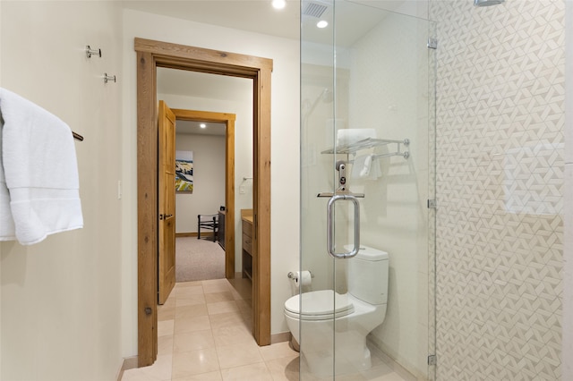 bathroom featuring vanity, tile flooring, a shower with door, and toilet