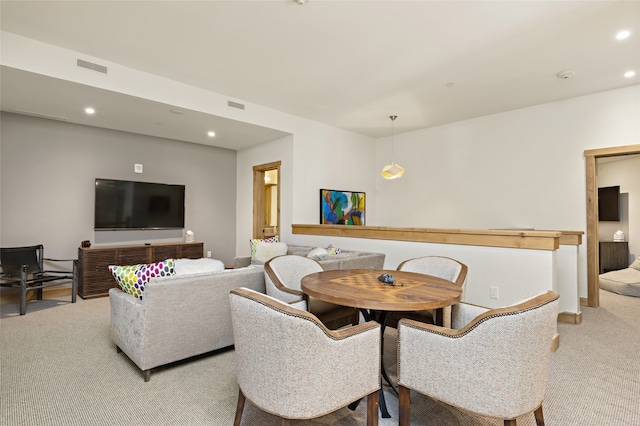 dining space featuring light carpet