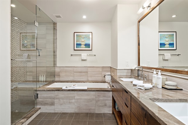 bathroom featuring shower with separate bathtub, tile flooring, double sink, and oversized vanity