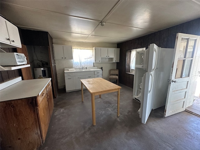 kitchen featuring white cabinets, sink, and white refrigerator