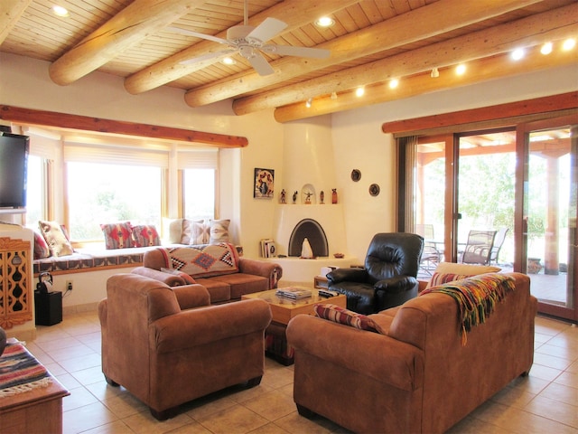 tiled living room with ceiling fan, beam ceiling, and a wealth of natural light