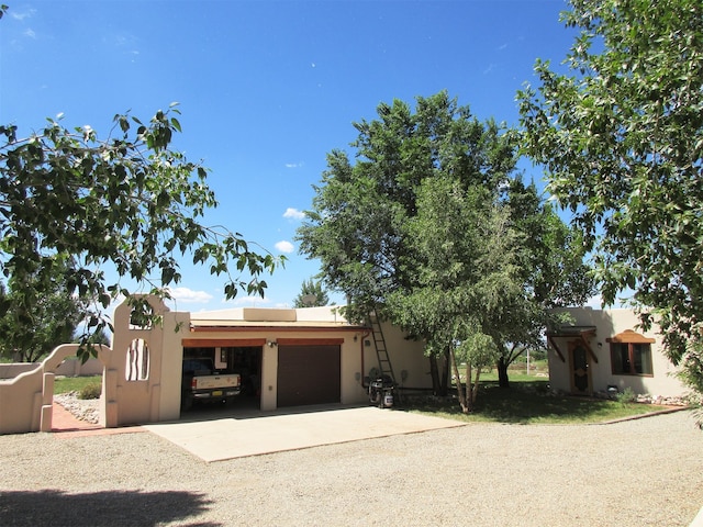 pueblo revival-style home with a garage