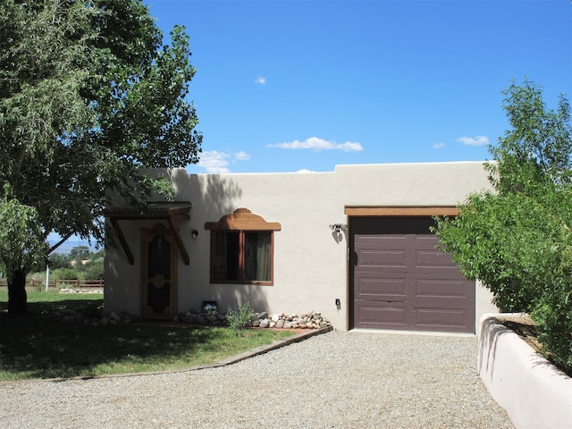 pueblo-style house with a garage