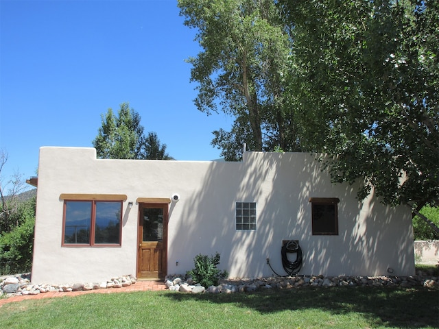 southwest-style home with a front lawn