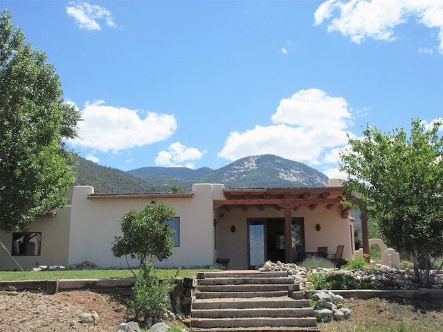 pueblo-style home with a mountain view