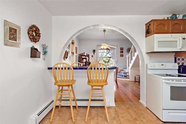 kitchen featuring white appliances, ceiling fan, a baseboard radiator, light hardwood / wood-style floors, and hanging light fixtures