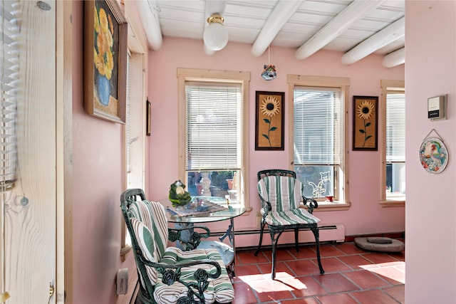 living area featuring beam ceiling, tile patterned flooring, and a baseboard heating unit