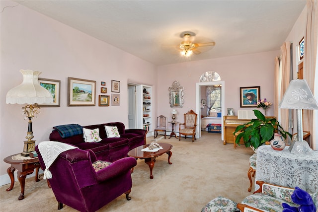 living room featuring ceiling fan and light colored carpet