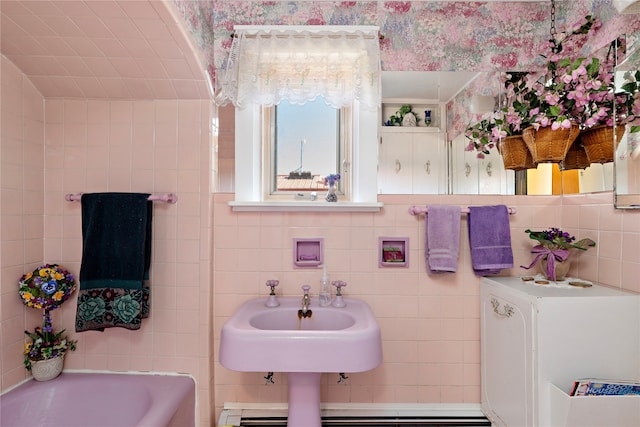 bathroom with a tub, sink, and tile walls