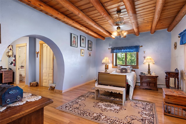 bedroom featuring ensuite bathroom, light hardwood / wood-style flooring, beamed ceiling, and wood ceiling