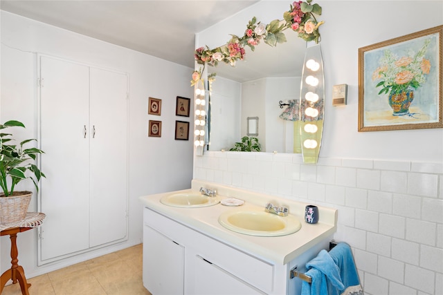 bathroom with tile patterned flooring, vanity, and tile walls