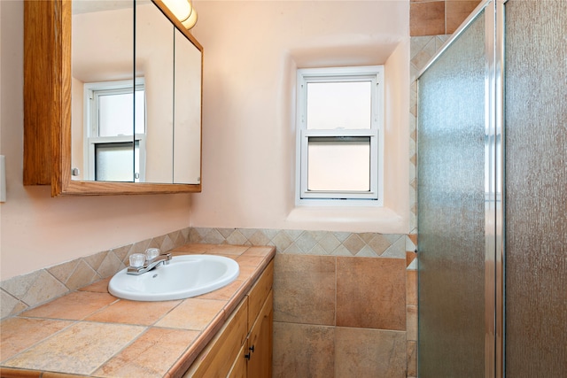 bathroom with vanity and a shower with shower door