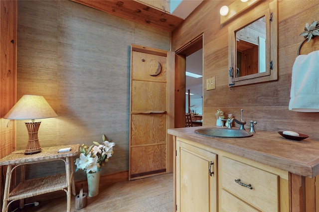 bathroom featuring wooden walls and oversized vanity