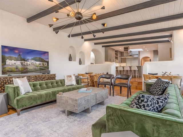 living room with light hardwood / wood-style flooring and beam ceiling