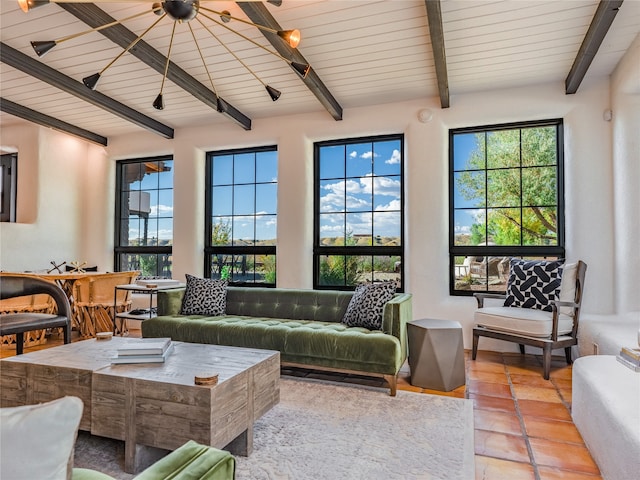 living room with light tile flooring, ceiling fan, and beam ceiling