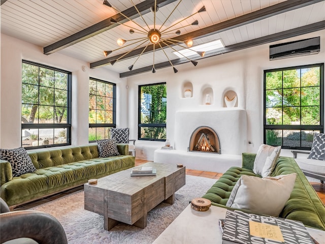 living room with a chandelier, beam ceiling, and a wealth of natural light