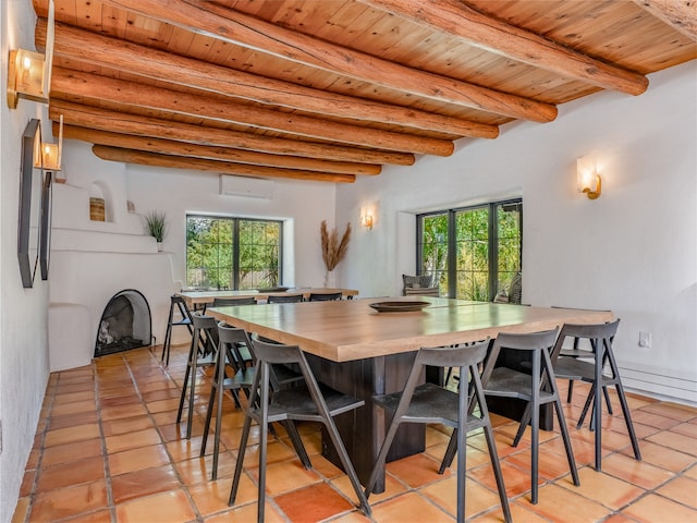 tiled dining space featuring a wall unit AC, wood ceiling, and beam ceiling