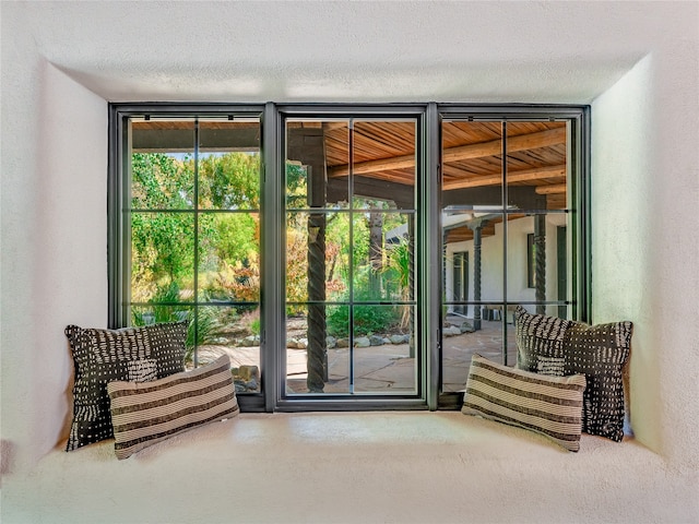 doorway to outside featuring expansive windows and a textured ceiling